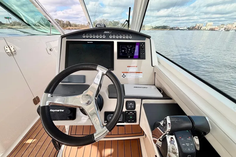  Yacht Photos Pics 2021 Boston Whaler 320 Vantage helm with Raymarine electronics and Mercury controls on water.