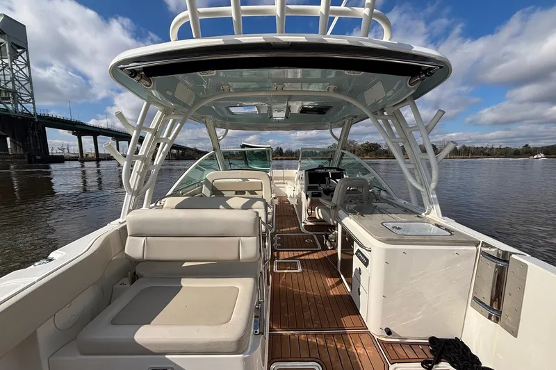  Yacht Photos Pics 2021 Boston Whaler 320 Vantage boat interior with seating and helm, on a sunny day.