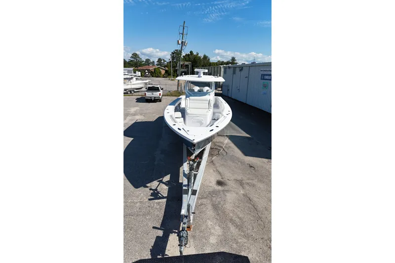  Yacht Photos Pics 2023 Jupiter 40 boat on trailer in outdoor lot, clear sky background.