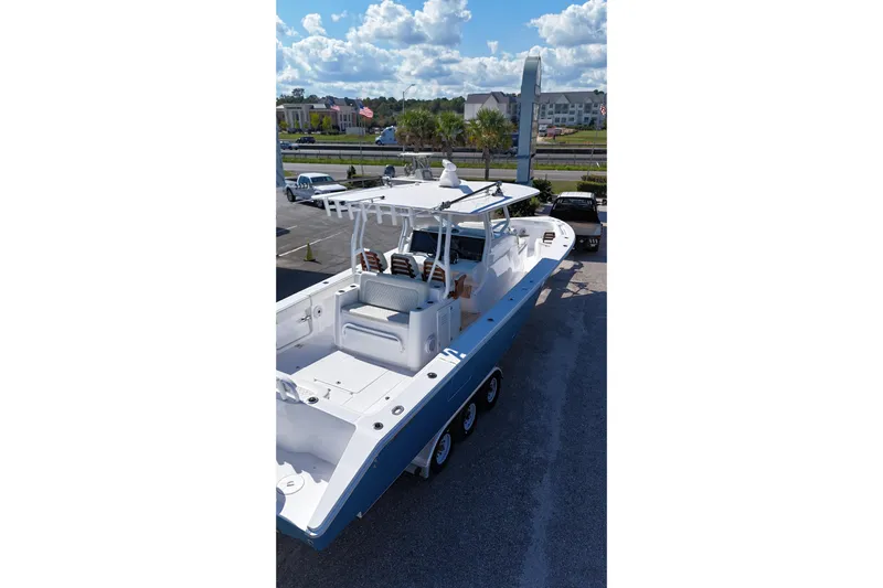  Yacht Photos Pics 2023 Jupiter 40 boat on trailer, parked outdoors under a partly cloudy sky.