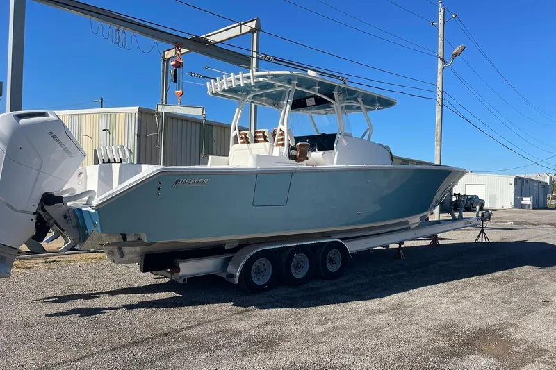  Yacht Photos Pics 2023 Jupiter 40 boat on trailer, parked outdoors under clear blue sky.