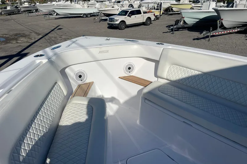  Yacht Photos Pics 2023 Jupiter 40 boat interior with white quilted seating and wood accents.