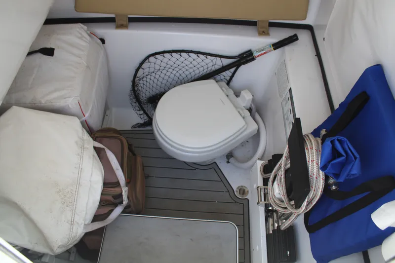  Yacht Photos Pics Interior of 2024 Sportsman Open 282 with toilet and gear storage.