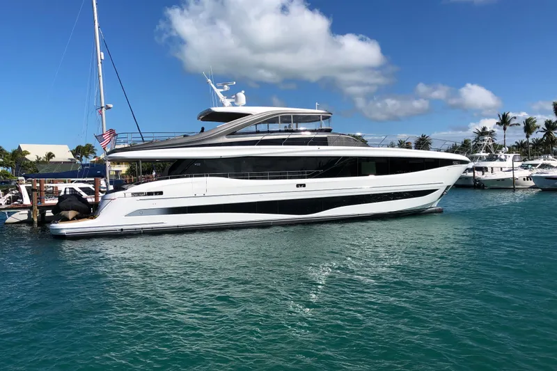Just Perfect Yacht Photos Pics 2025 Princess Y95 Motor Yacht docked in a sunny marina, surrounded by palm trees.