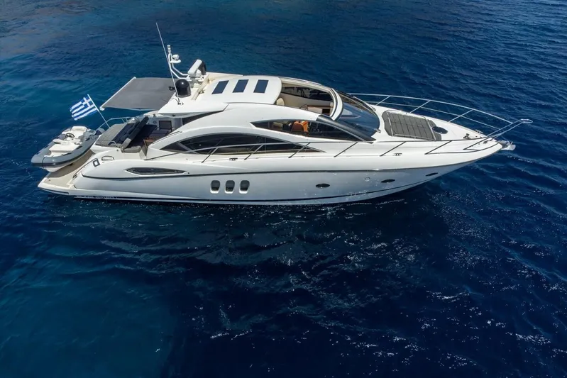 M/y Seaduced Yacht Photos Pics 2009 Sunseeker Predator 52 yacht cruising on clear blue waters.