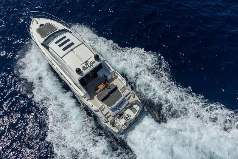 M/y Seaduced Yacht Photos Pics Aerial view of 2009 Sunseeker Predator 52 yacht cruising on open sea.