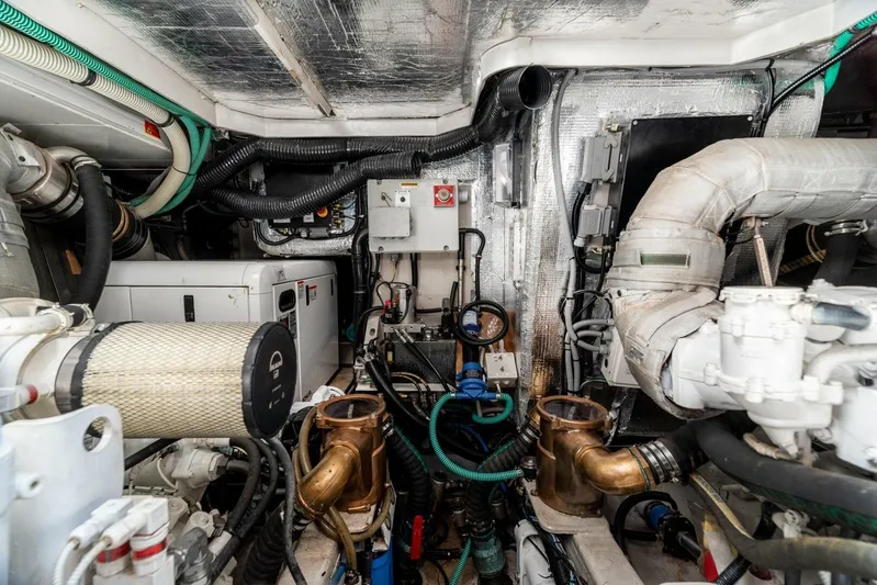 M/y Seaduced Yacht Photos Pics Engine room of 2009 Sunseeker Predator 52 yacht, showcasing complex machinery and piping.