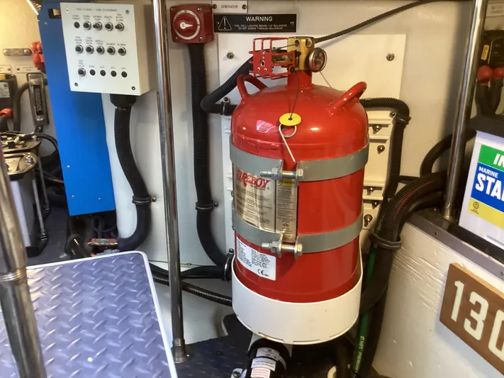 Steal Yacht Photos Pics Engine room of 2020 Formula 380 Super Sport Crossover with fire extinguisher and control panel.