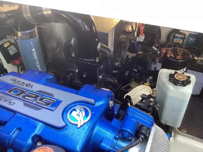 Steal Yacht Photos Pics Engine compartment of a 2020 Formula 380 Super Sport Crossover with blue engine components.