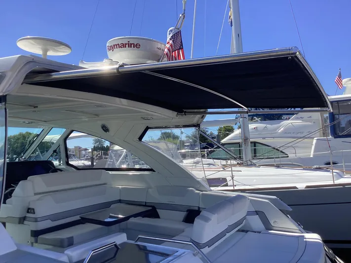 Steal Yacht Photos Pics 2020 Formula 380 Super Sport Crossover yacht with shaded seating area at marina.