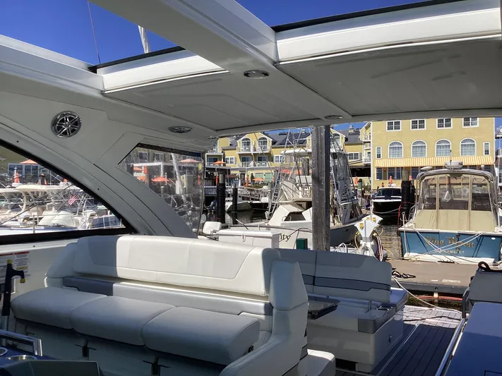 Steal Yacht Photos Pics 2020 Formula 380 Super Sport Crossover yacht interior at marina, featuring luxurious seating.