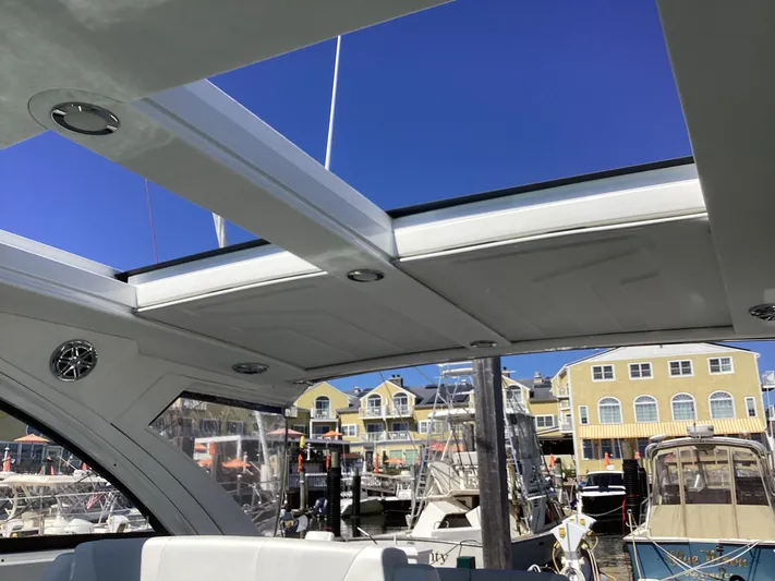 Steal Yacht Photos Pics 2020 Formula 380 Super Sport Crossover boat interior with open roof, docked at marina.