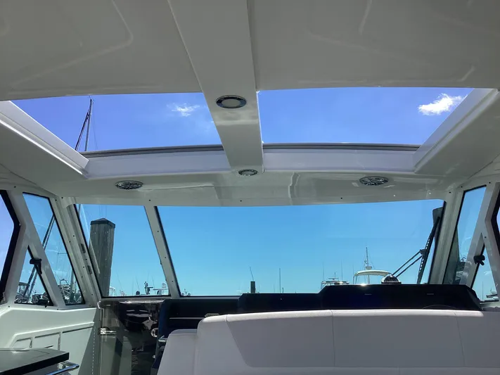 Steal Yacht Photos Pics Interior view of 2020 Formula 380 Super Sport Crossover boat with skylight and blue sky.