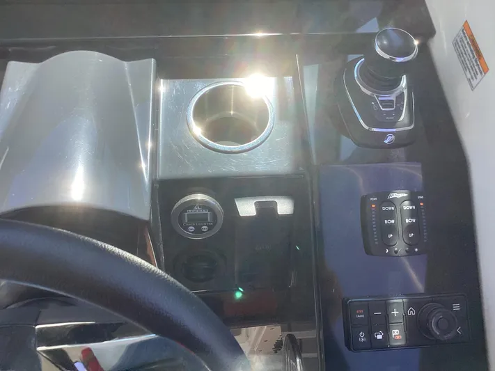 Steal Yacht Photos Pics Control panel of a 2020 Formula 380 Super Sport Crossover boat with cup holder and joystick.