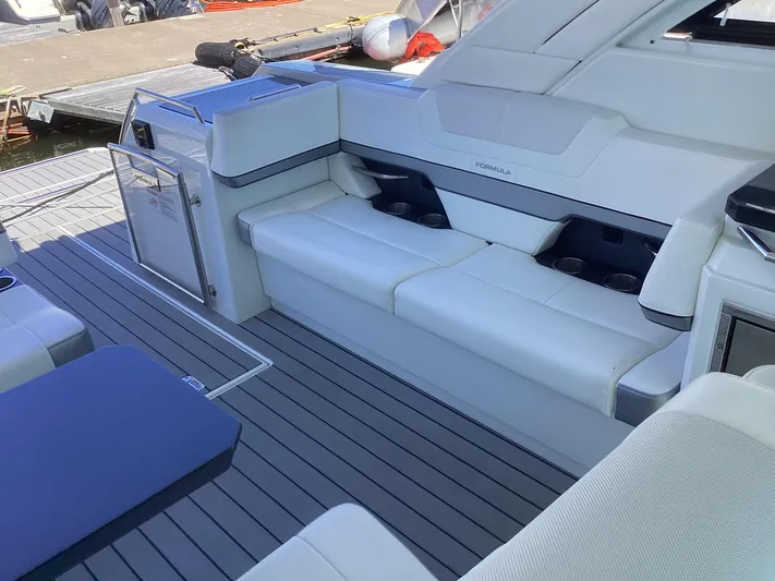 Steal Yacht Photos Pics 2020 Formula 380 Super Sport Crossover boat interior with white seating and sleek design.
