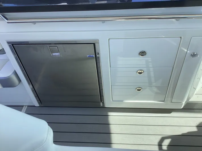 Steal Yacht Photos Pics 2020 Formula 380 Super Sport Crossover boat interior with stainless steel fridge and storage drawers.