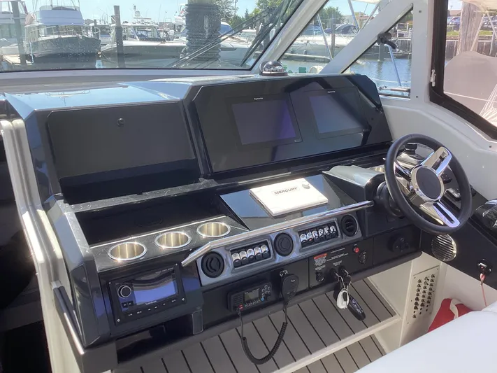 Steal Yacht Photos Pics 2020 Formula 380 Super Sport Crossover helm with modern controls and sleek design.