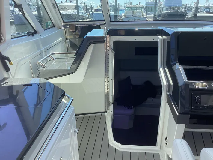 Steal Yacht Photos Pics 2020 Formula 380 Super Sport Crossover interior with open cabin door and sleek design.