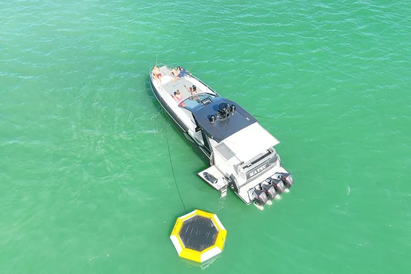 Matzu Yacht Photos Pics 2023 Azimut Verve 47 yacht on turquoise water with people relaxing onboard.