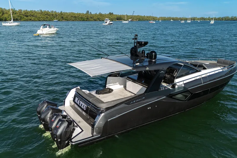 Matzu Yacht Photos Pics 2023 Azimut Verve 47 luxury yacht on a serene waterway with other boats.