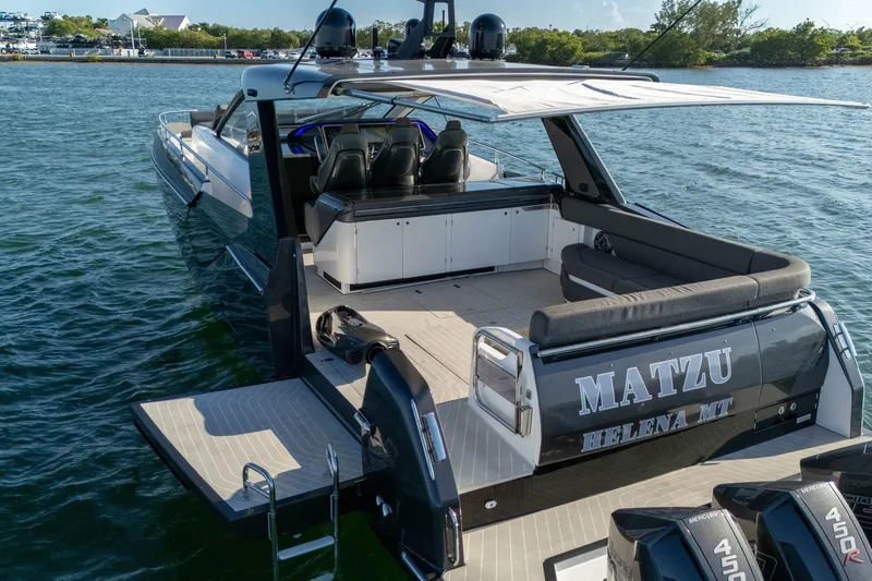 Matzu Yacht Photos Pics 2023 Azimut Verve 47 luxury yacht on water, rear view with seating and engines.