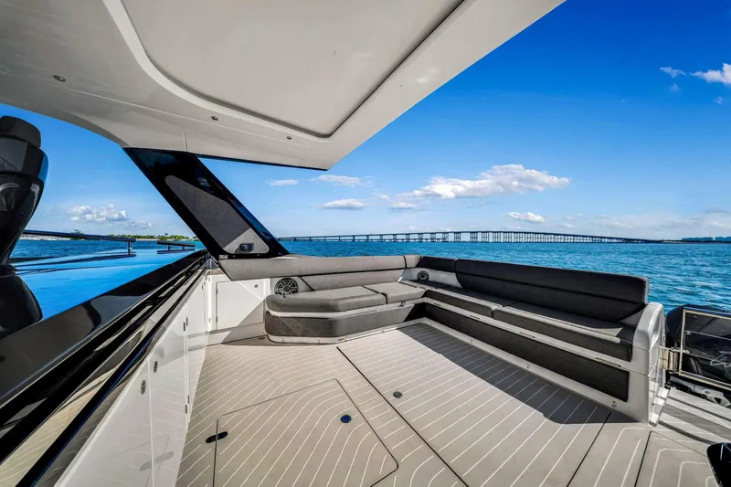 Matzu Yacht Photos Pics 2023 Azimut Verve 47 yacht with spacious deck, overlooking serene blue waters and distant bridge.