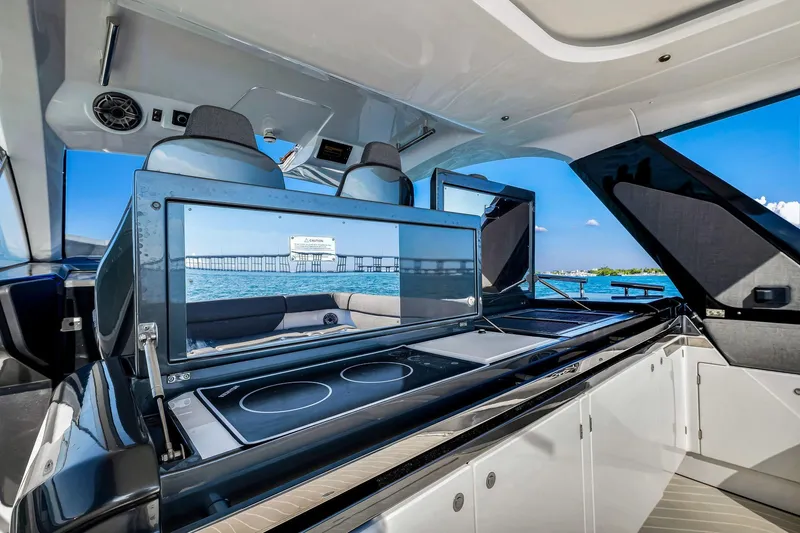 Matzu Yacht Photos Pics Luxurious 2023 Azimut Verve 47 yacht interior with modern kitchen and ocean view.