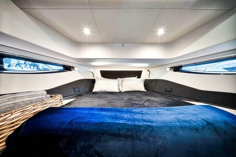 Matzu Yacht Photos Pics Luxurious interior cabin of 2023 Azimut Verve 47 yacht with plush bedding.