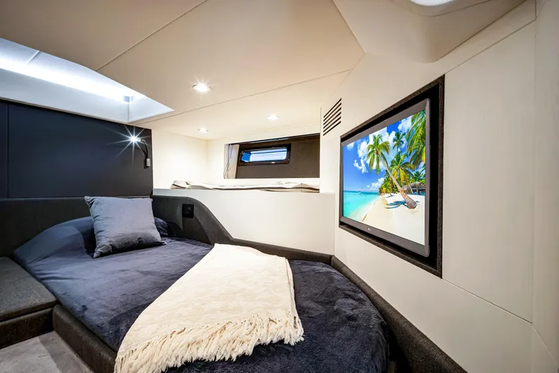 Matzu Yacht Photos Pics Luxurious cabin interior of 2023 Azimut Verve 47 yacht with cozy bed and TV.