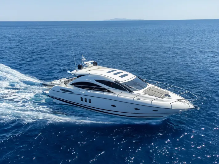 M/y Seaduced Yacht Photos Pics 2009 Sunseeker Predator 52 yacht cruising on open blue sea.