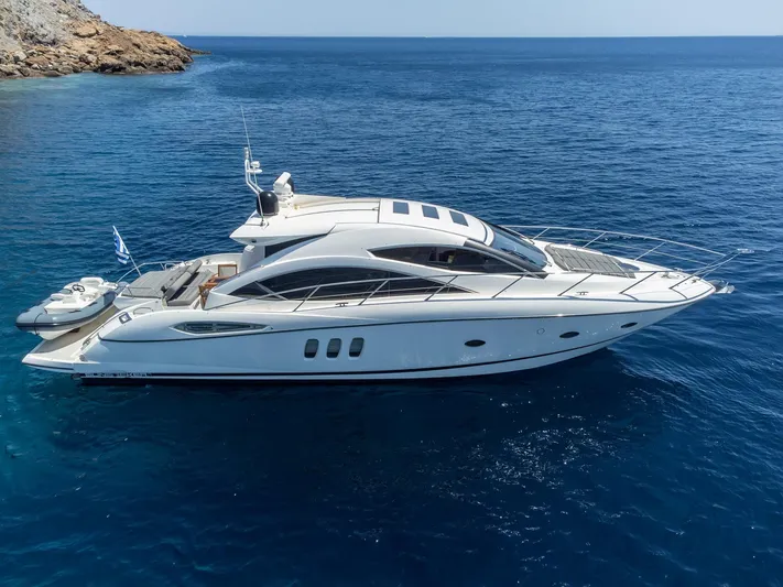 M/y Seaduced Yacht Photos Pics 2009 Sunseeker Predator 52 yacht cruising in clear blue waters.