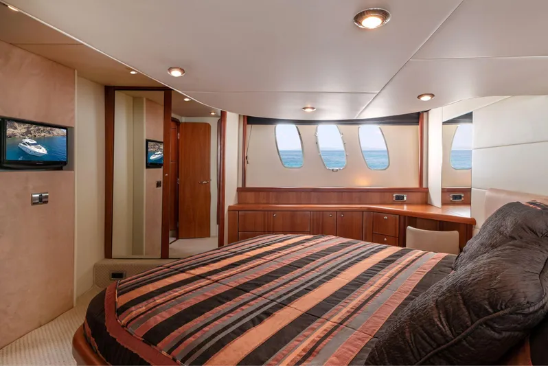 M/y Seaduced Yacht Photos Pics Luxurious bedroom interior of 2009 Sunseeker Predator 52 yacht with striped bedding.