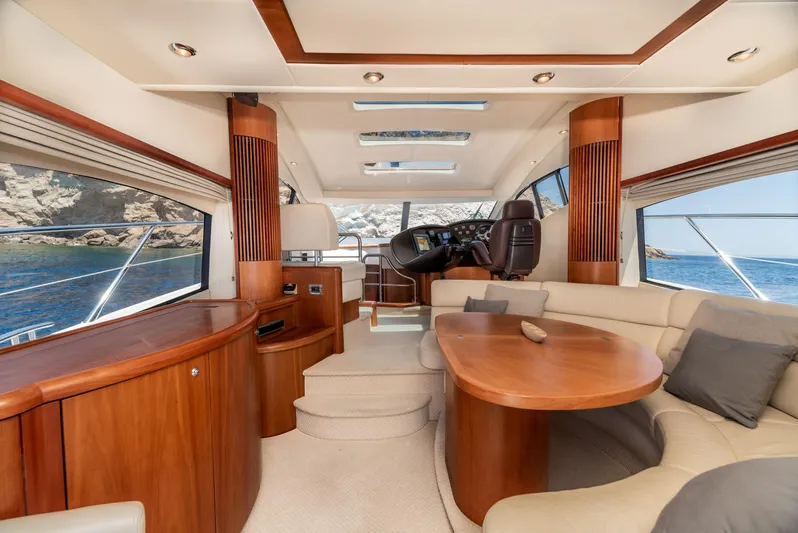 M/y Seaduced Yacht Photos Pics Luxurious interior of 2009 Sunseeker Predator 52 yacht with elegant wood finishes and plush seating.