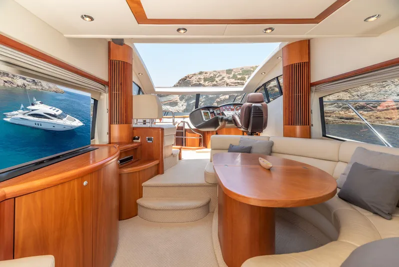 M/y Seaduced Yacht Photos Pics Luxurious interior of 2009 Sunseeker Predator 52 yacht with elegant wood finishes and scenic views.