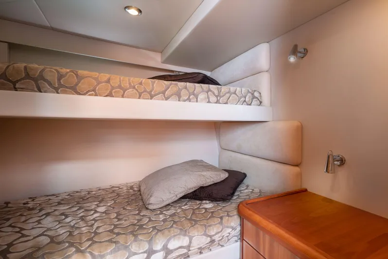 M/y Seaduced Yacht Photos Pics Bunk beds in 2009 Sunseeker Predator 52 yacht cabin, featuring modern design and cozy bedding.