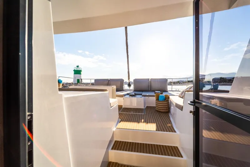 Signature Bali 5.4. (5+2 Cabins) Yacht Photos Pics Luxurious Bali 5.4 catamaran deck with seating, 2021 model, overlooking serene waters.