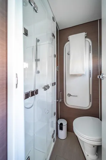 Signature Bali 5.4. (5+2 Cabins) Yacht Photos Pics Modern yacht bathroom with glass shower, toilet, and towel rack. Bali 5.4, 2021 model.