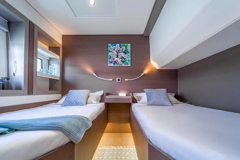 Signature Bali 5.4. (5+2 Cabins) Yacht Photos Pics Luxurious Bali 5.4 yacht cabin interior with twin beds, modern decor, and soft lighting, 2021 model.