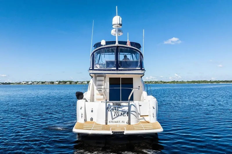  Yacht Photos Pics 2008 Meridian 411 Sedan yacht on calm water under clear blue sky.