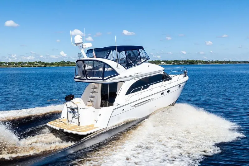  Yacht Photos Pics 2008 Meridian 411 Sedan cruising on a clear blue lake under a sunny sky.