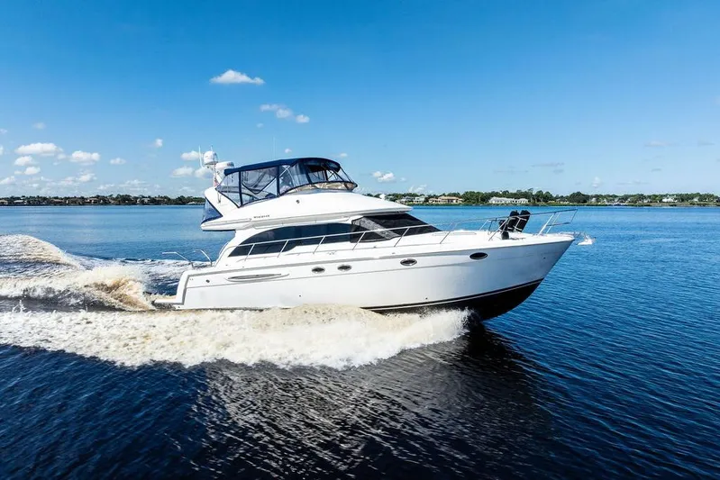  Yacht Photos Pics 2008 Meridian 411 Sedan cruising on a clear blue lake under a sunny sky.