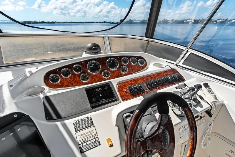  Yacht Photos Pics Dashboard of 2008 Meridian 411 Sedan yacht with gauges and controls, overlooking calm waters.