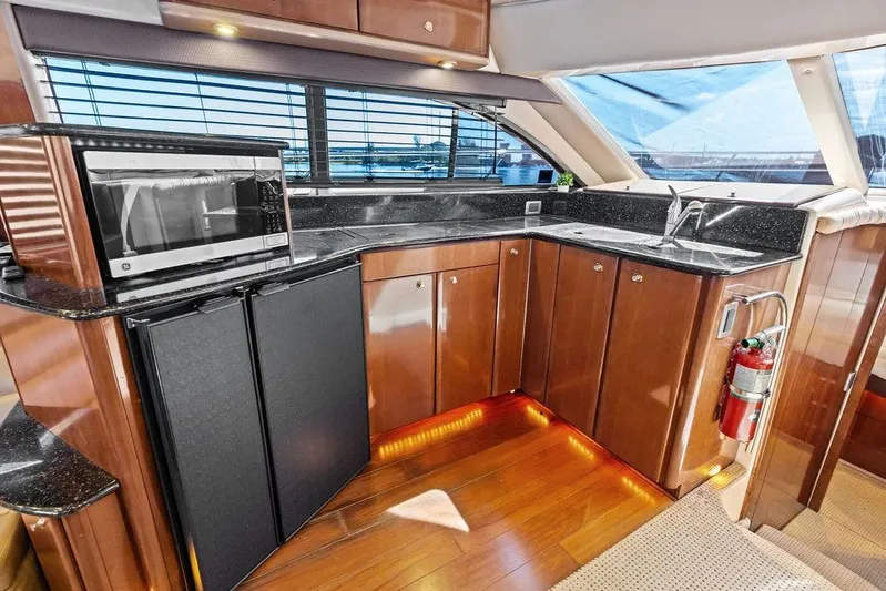  Yacht Photos Pics Luxurious 2008 Meridian 411 Sedan yacht kitchen with modern appliances and elegant wood cabinetry.