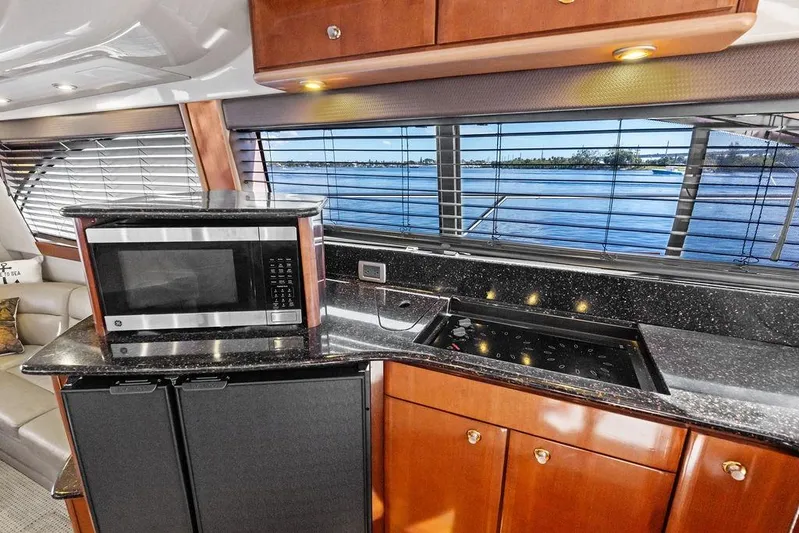  Yacht Photos Pics Luxurious 2008 Meridian 411 Sedan yacht kitchen with microwave, stove, and scenic water view.