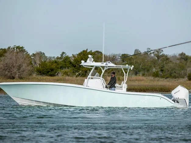  Yacht Photos Pics 2025 Yellowfin 34 Offshore boat cruising on calm water, side view.