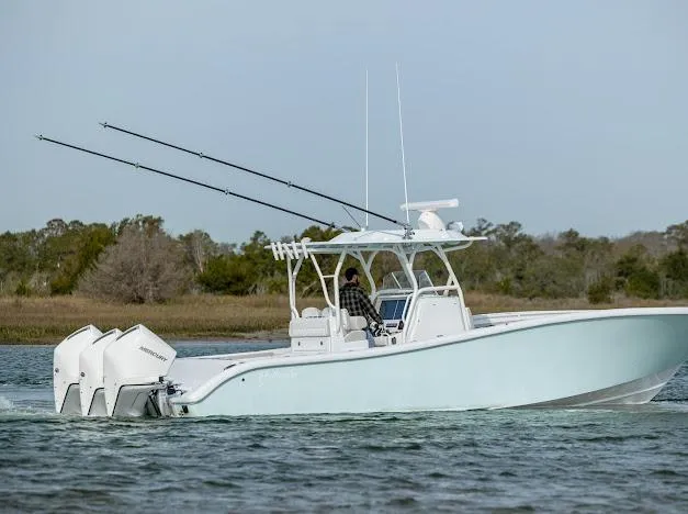  Yacht Photos Pics 2025 Yellowfin 34 Offshore boat cruising on a calm waterway.