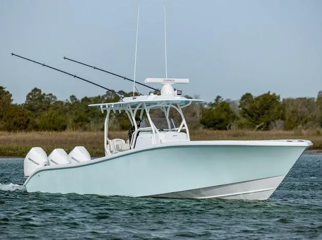  Yacht Photos Pics 2025 Yellowfin 34 Offshore boat cruising on water with fishing rods.