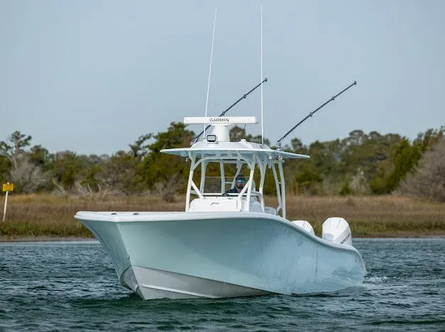  Yacht Photos Pics 2025 Yellowfin 34 Offshore boat on water, featuring sleek design and fishing rods.