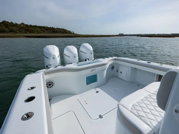  Yacht Photos Pics 2025 Yellowfin 34 Offshore boat with triple Mercury engines on calm water.