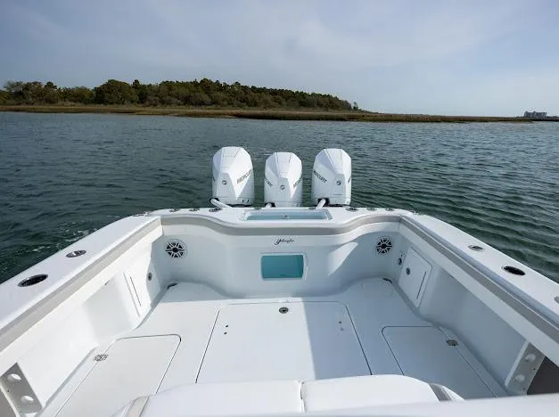  Yacht Photos Pics 2025 Yellowfin 34 Offshore boat with triple engines on calm water.